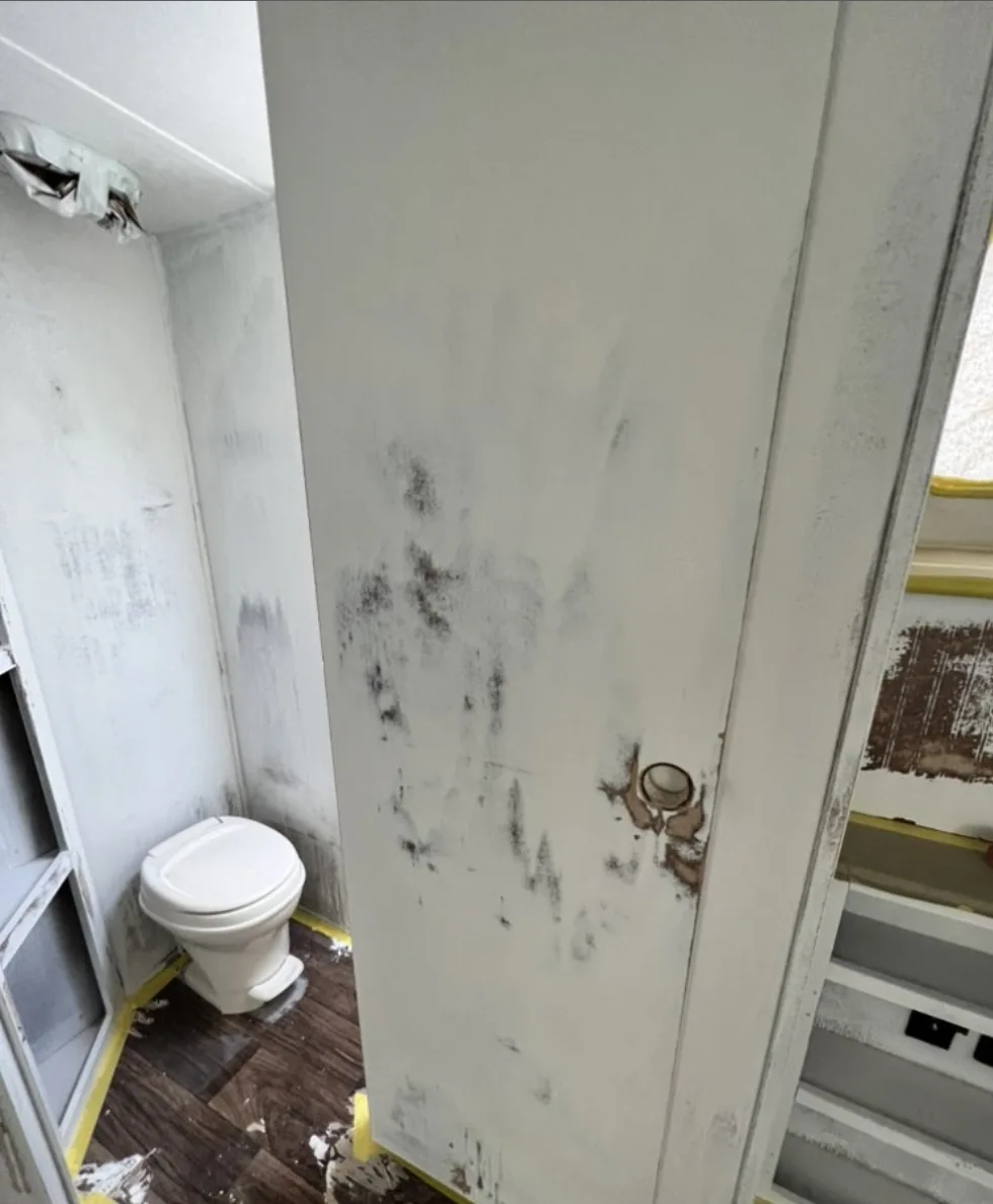 RV bathroom showing visible wall damage before work