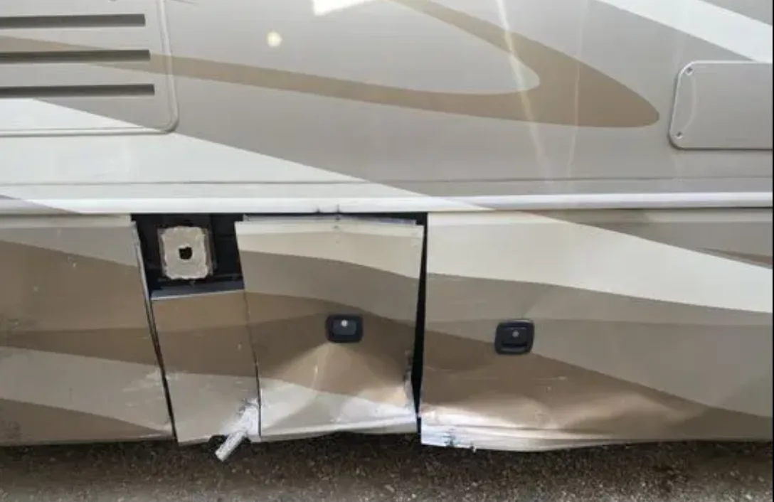 Damaged motorhome side panel before exterior repair